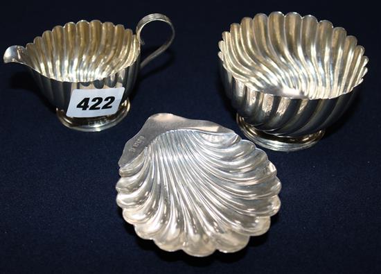 A silver sugar bowl and milk jug and a silver shell shaped butter dish, 5 oz.